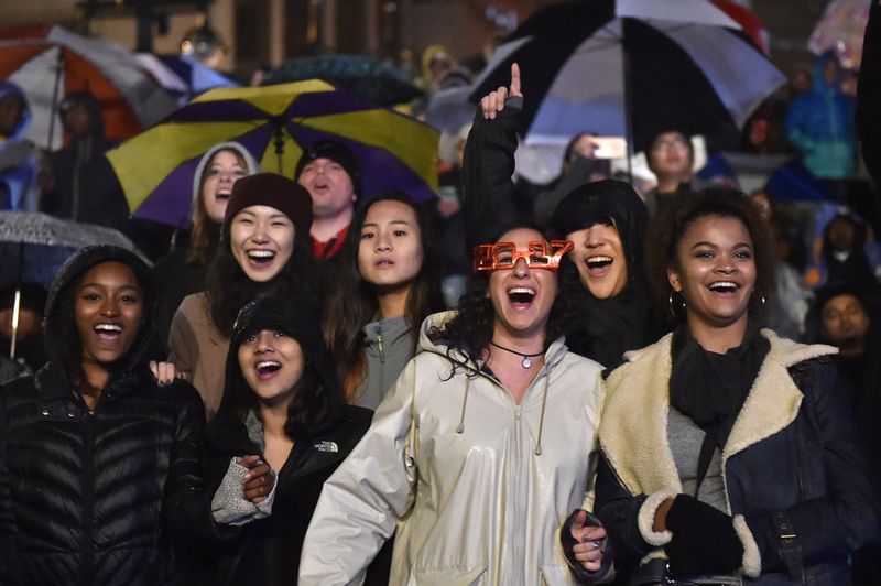 December 31, 2016, Atlanta - Spectators cheer during a DJ set in the rain during the Peach Drop in Atlanta, Georgia, on Saturday, December 31, 2016. (DAVID BARNES / DAVID.BARNES@AJC.COM)