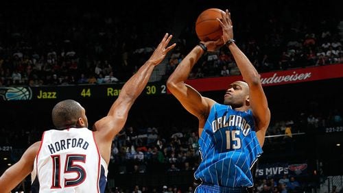 Vince Carter, No. 15 of the Orlando Magic shoots against Al Horford, No. 15, of the Atlanta Hawks at Philips Arena on March 24, 2010 in Atlanta, Georgia.