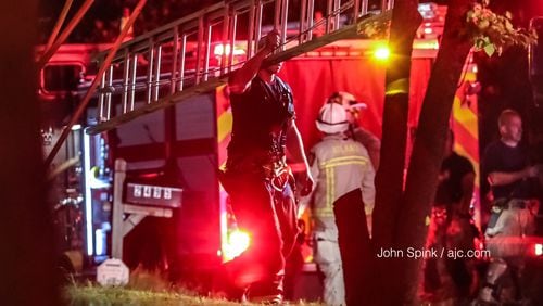 Crews with Atlanta Fire Rescue were on the scene of an early  morning fire on Harvel Drive July 3. Investigators later determined that a man and his wife were strangled before their home caught fire. JOHN SPINK / JSPINK@AJC.COM