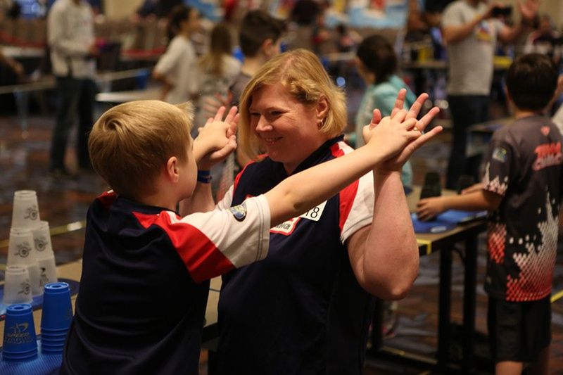 P.J. Ball gives his mother, Tasha, a high-five before competing in a sport stacking event in which competitors stack cups in formation and take them down as fast as possible. CONTRIBUTED