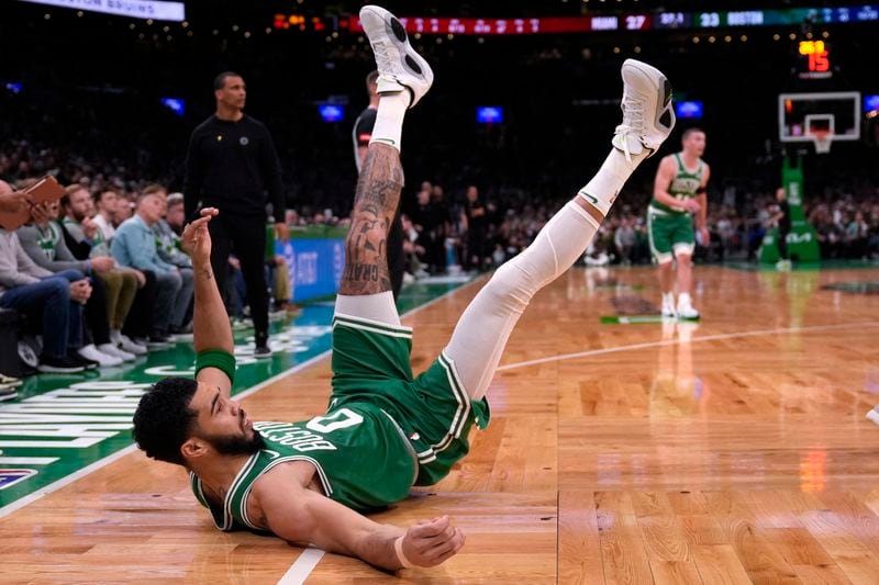 Boston Celtics forward Jayson Tatum hits the floor after a shot against the Miami Heat during the first half of Game 2 of an NBA basketball first-round playoff series, Wednesday, April 24, 2024, in Boston. (AP Photo/Charles Krupa)