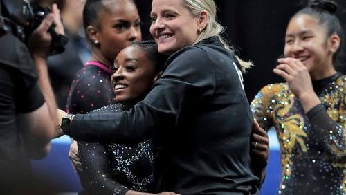 FILE - Simone Biles gets a hug from her coach, Cecile Landi, after competing in the floor exercise in the U.S. Gymnastics Championships, Aug. 27, 2023, in San Jose, Calif. Landi agreed Thursday, April 25, 2024, to become the co-head coach of the women's gymnastics program at Georgia. (Carlos Avila Gonzalez/San Francisco Chronicle via AP, File)