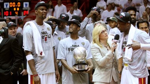 Heat players Chris Bosh (from left), Norris Cole (30), and Dwyane Wade (shown talking with ESPN's Doris Burke), begin celebrating after a Game 7 win over the Celtics that puts Miami in the 2012 NBA Finals.