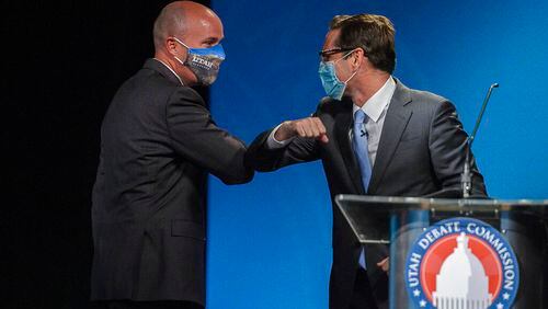 This photo taken Sept. 29, 2020, shows Utah Lt. Gov. Spencer Cox, left, a Republican and Democratic challenger Chris Peterson, rivals to become Utah's next governor, bumping elbows after facing each other in a prime-time debate in Salt Lake City. The two released dual ads calling for "civility." (Trent Nelson/The Salt Lake Tribune, via AP, Pool)