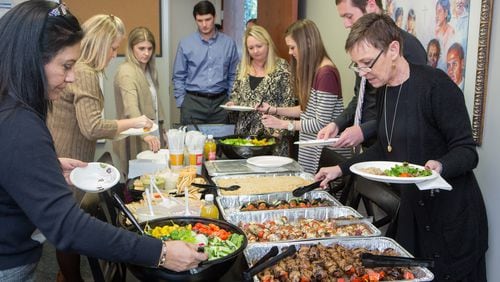 Supreme Lending employees gather for a lunch to celebrate the months closing in Alpharetta on January 31st, 2017. Supreme Lending is the small employer AJC Top Workplace winner. (Photo by Phil Skinner)