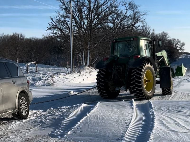 A local Iowa farmer tows Georgia state Rep. Scott Hilton’s car out of a snowy ditch in rural Iowa. (Courtesy photo)