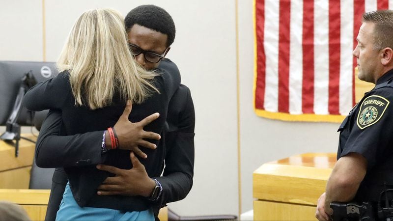 Murder victim Botham Jean's younger brother, Brandt Jean, hugs Amber Guyger, the former Dallas police officer who killed his brother, after delivering his impact statement Wednesday, Oct. 2, 2019, in Dallas. Guyger, 31, was sentenced to 10 years.