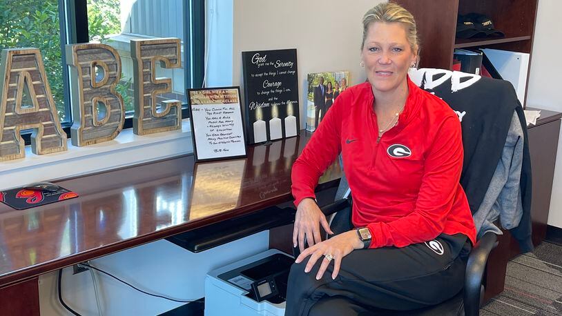 First-year Georgia women's basketball coach Katie Abrahamson-Henderson, better known to everyone as "Coach ABE," poses at UGA's Coliseum Training Facility in Athens. She said her desk is so neat because she has spent almost no time sitting at it since being named the third coach of the women's basketball program on March 26. (Photo by Chip Towers/ctowers@ajc.com)