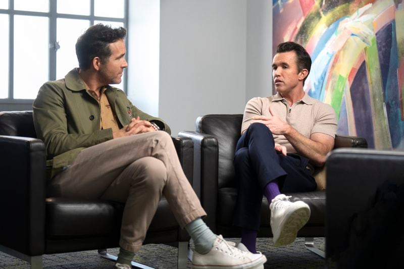 This image released by FX shows Ryan Reynolds, left, and Rob McElhenney in a scene from the third season of "Welcome to Wrexham." (Ben Hider/FX via AP)