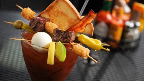 The Bloody Best - A 32 oz glass with 6 ounces of Absolute Peppar Vodka mixed with spicy Bloody Mary mix, topped with pepperoncinis, blue cheese stuffed olives, tots, steak, a slice of toast, bacon and a hard boiled egg and a beef straw at The Nook. (BECKYSTEINPHOTOGRAPHY.COM)