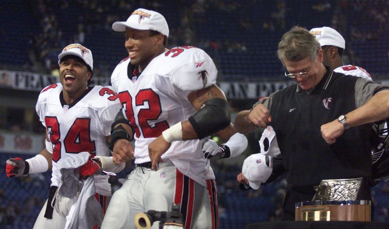 Falcons coach Dan Reeves (right) does the dirty bird dance with players Jamal Anderson (32) and Ray Buchanan (34) after clinching the NFC title in 1999. 