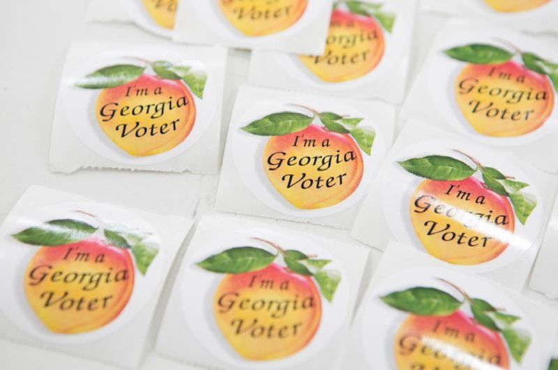 More than 100,000 Georgians are no longer eligible to display the state's voting stickers because their inactivity led to the cancellation of the registrations.