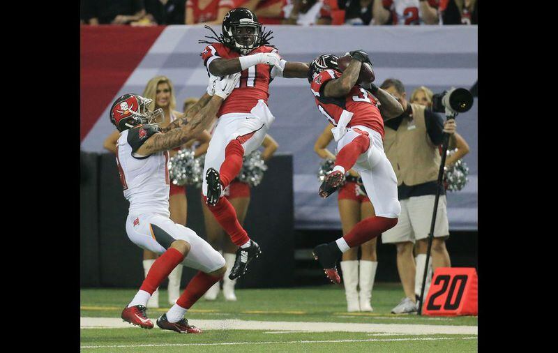 Falcons cornerback Desmond Trufant is called for pass interference against Buccaneers wide receiver Mike Evans as safety Ricardo Allen makes what may have been an interception during the second half in a football game on Sunday, Nov. 1, 2015, in Atlanta. The Falcons were defeated 23-20 by the Buccaneers in over time. (Curtis Compton/Ccompton@ajc.com)