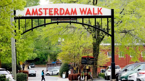 A person crosses the street by Amsterdam Walk shopping center on Tuesday, April 4, 2023.  Portman Holdings is pursuing a plan to redevelop Amsterdam Walk, a 9-acre shopping center along the Beltline and Piedmont Park.  Miguel Martinez / miguel.martinezjimenez@ajc.com