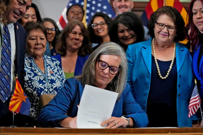 Arizona Gov. Katie Hobbs, D, signs the repeal of the Civil War-era near-total abortion ban, Thursday, May 2, 2024, at the Capitol in Phoenix. Democrats secured enough votes in the Arizona Senate to repeal the ban on abortions that the state's highest court recently allowed to take effect. (AP Photo/Matt York)