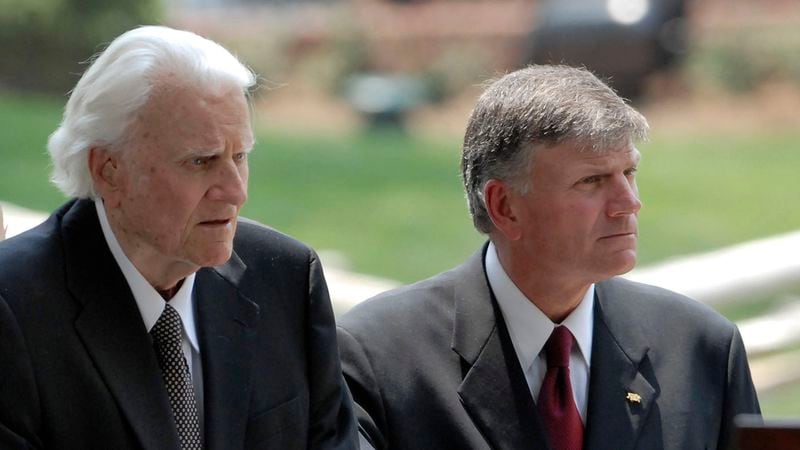 Franklin Graham (R) helps his father Billy Graham to the stage during the Billy Graham Library Dedication Service on May 31, 2007 in Charlotte, North Carolina. Franklin Graham posted a tribute to his father, who died Feb., 21, 2018, on Facebook.