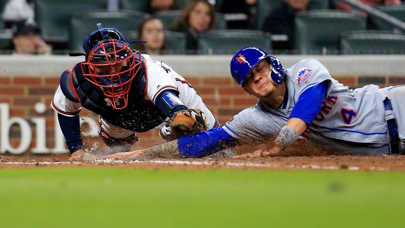 Braves catcher Kurt Suzuki made an impressive diving play to tag out Wilmer Flores at the plate in the sixth inning Friday. (Photo by Daniel Shirey/Getty Images)