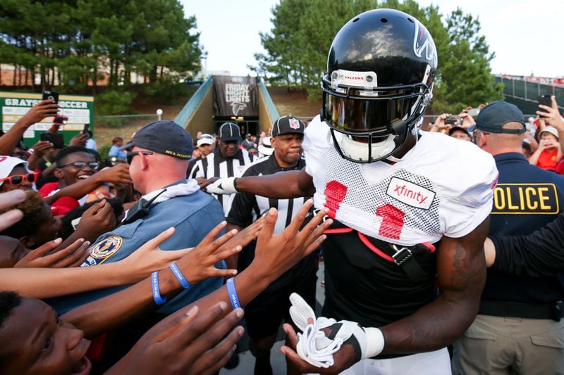 Fans reach out for Atlanta Falcons wide receiver Julio Jones (11) during the ninth annual "Kia Motors Friday Night Lights" at Grayson High School, Friday, August 5, 2016, in Loganville, Ga. BRANDEN CAMP/SPECIAL