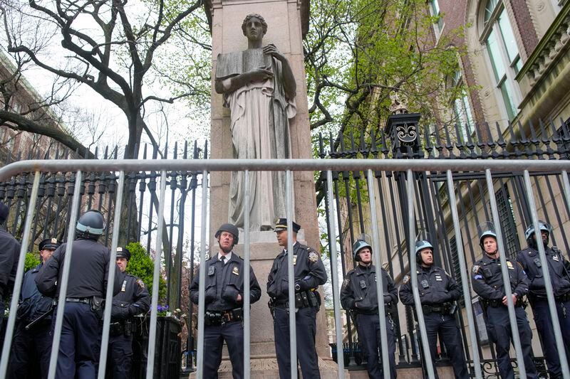 New York City police in riot gear stand guard outside the Columbia University campus after clearing the campus of protesters, Thursday, April 18, 2024, in New York. The protesters were calling for the school to divest from corporations profiting from the war in the Middle East. (AP Photo/Mary Altaffer)