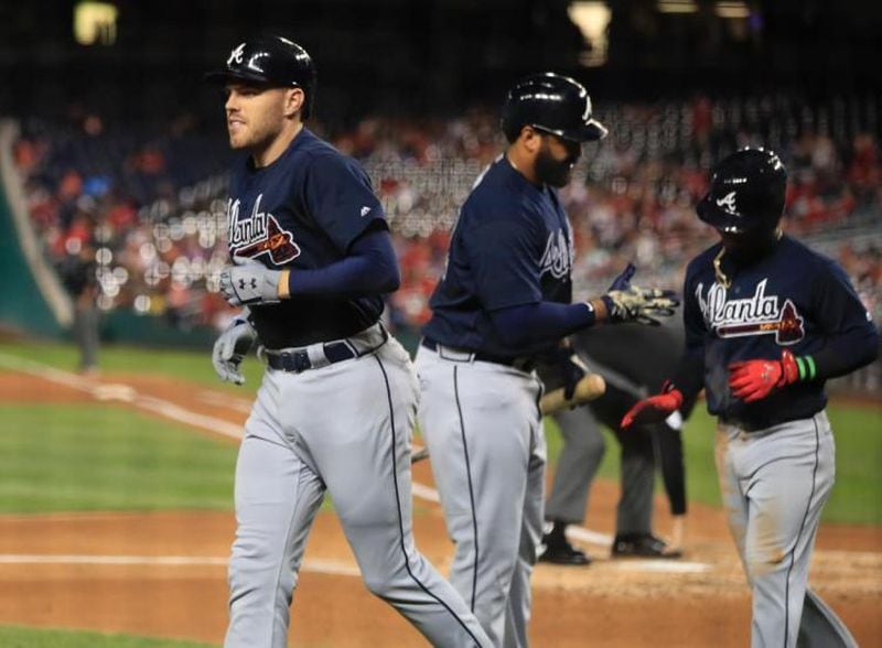  Freddie Freeman returns to the dugout after crushing a three-run homer against Nationals lefty Gio Gonzalez on Tuesday at Nationals Park. (AP photo)