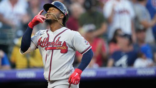 Braves second baseman Ozzie Albies gestures as he crosses home plate after hitting a solo home run off Colorado Rockies starting pitcher German Marquez in the third inning Saturday, Sept. 4, 2021, in Denver. (David Zalubowski/AP)
