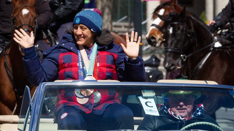 Honorary grand marshal and Olympic medalist Elana Meyers Taylor waves to the crowd during the Atlanta St. Patrick's Parade in Midtown on Saturday, March 12, 2022. (Photo by Steve Schaefer for The Atlanta Journal-Constitution)