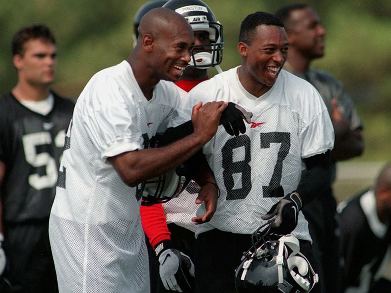 Falcons' newest acquisition wide receiver Michael Haynes (left) jokes with his friend Bert Emanuel (87) during workouts at the team's training camp Friday, June 13, 1997. Haynes rejoins the Falcons to improve the offense. (David Tulis/AJC)