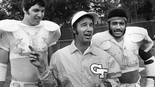 Georgia Tech coach Pepper Rodgers (middle) stands with players Billy Shields (left) and Joe Harris (right) at practice in 1974. (AJC file photo by Billy Downs)
