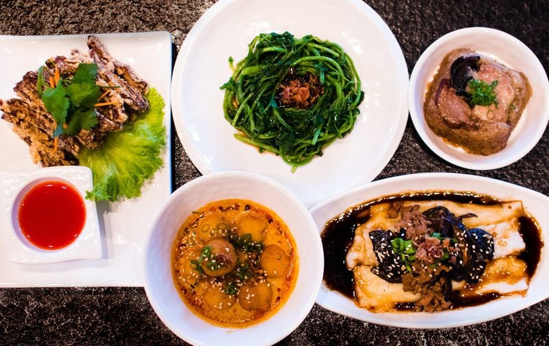A spread of small plates at Food Terminal (clockwise from left): crispy pig ears, watercress with black bean, nuomiji, shiitake ground pork and curry fish balls. CONTRIBUTED BY HENRI HOLLIS