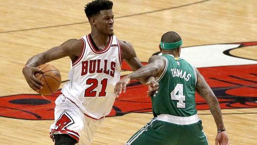Chicago Bulls' Jimmy Butler (21) is fouled by Boston Celtics' Isaiah Thomas during the second half in Game 4 of an NBA basketball first-round playoff series in Chicago, Sunday, April 23, 2017. The Celtics won 104-95. (AP Photo/Charles Rex Arbogast)