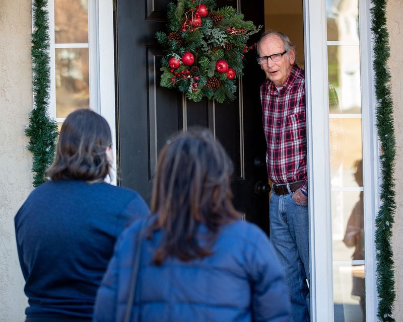 Republican canvassers Claudia Eisenburg and Savannah Viar talk with Ty Wilson at his Peachtree City home on Dec. 14, 2020. (Steve Schaefer for The Atlanta Journal-Constitution)