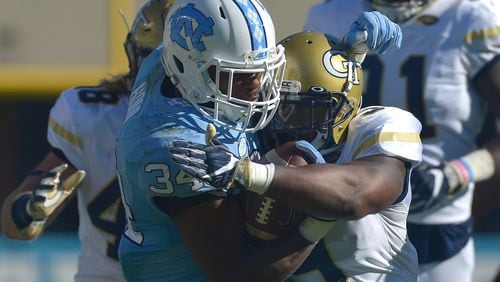 Victor Alexander #9 of the Georgia Tech Yellow Jackets tackles Elijah Hood #34 of the North Carolina Tar Heels during the game at Kenan Stadium on November 5, 2016 in Chapel Hill, North Carolina. North Carolina won 48-20. (Photo by Grant Halverson/Getty Images)