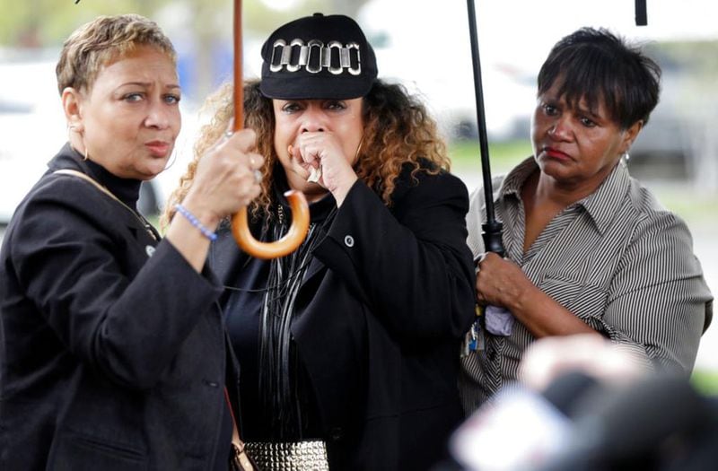 A woman, center, who would only be identified as the godmother of shooting victim DeEbony Groves, cries as she listens at a news conference regarding the capture of Travis Reinking Monday, April 23, 2018, in Nashville, Tenn. Reinking, who police say shot and killed at least four people Sunday at a Waffle House restaurant, was captured Monday in a wooded area near his apartment complex and the restaurant. Groves, 21, was a student at Nashville's Belmont University. (AP Photo/Mark Humphrey)