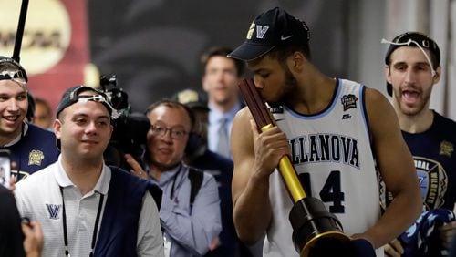 Villanova's Omari Spellman kisses the championship trophy as he walks to the locker room after the championship game of the Final Four. The Hawks selected Spellman with the No. 30 overall pick in the NBA draft last month.