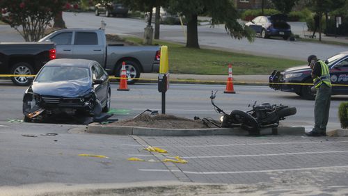 Authorities investigate a serious crash involving a motorcycle at the entrance to the McDonald's in the 400 block of Moreland Avenue.