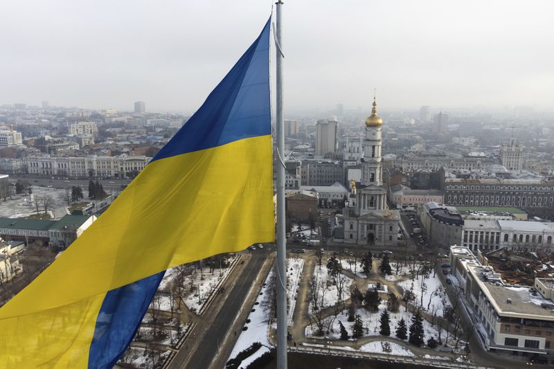 FILE - A Ukrainian national flag waves over the center of Kharkiv, Ukraine's second-largest city, Feb. 16, 2022. U.S. officials say Ukraine for the first time has begun using long-range ballistic missiles, striking a Russian military airfield in Crimea and Russian troops in another occupied area overnight. (AP Photo/Mstyslav Chernov, File)