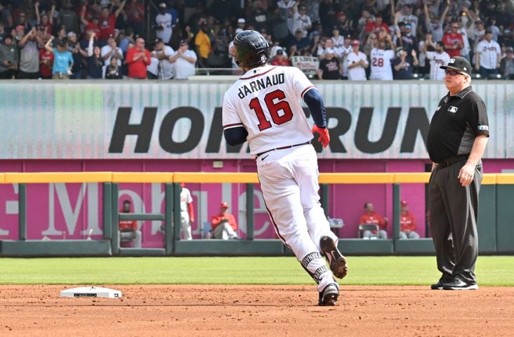 Atlanta Braves' Travis d'Arnaud hits a solo home run during the second inning of game one of the baseball playoff series between the Braves and the Phillies at Truist Park in Atlanta on Tuesday, October 11, 2022. (Hyosub Shin / Hyosub.Shin@ajc.com)