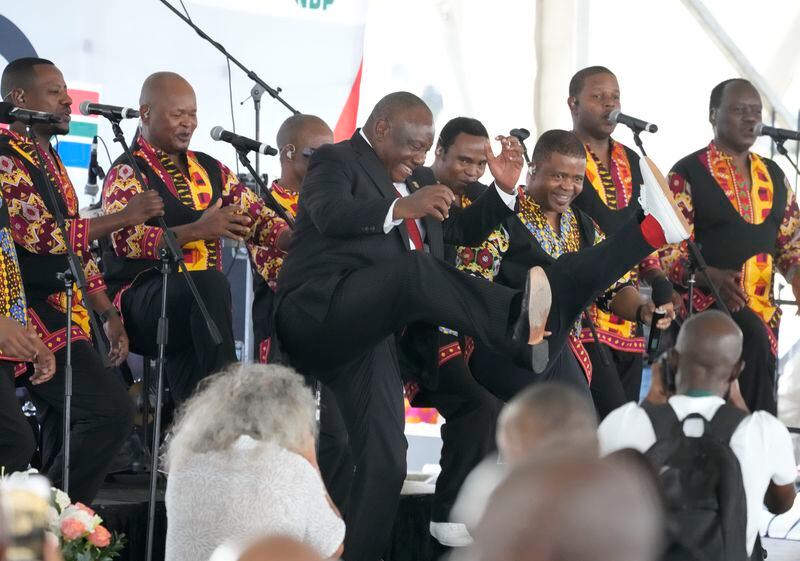 South African President Cyril Ramaphosa, centre, dances to music as he attends Freedom Day celebrations in Pretoria, South Africa, Saturday April 27, 2024. The day marks April 27 when the country held pivotal first democratic election in 1994 that announced the official end of the racial segregation and oppression of apartheid. (AP Photo/Themba Hadebe)