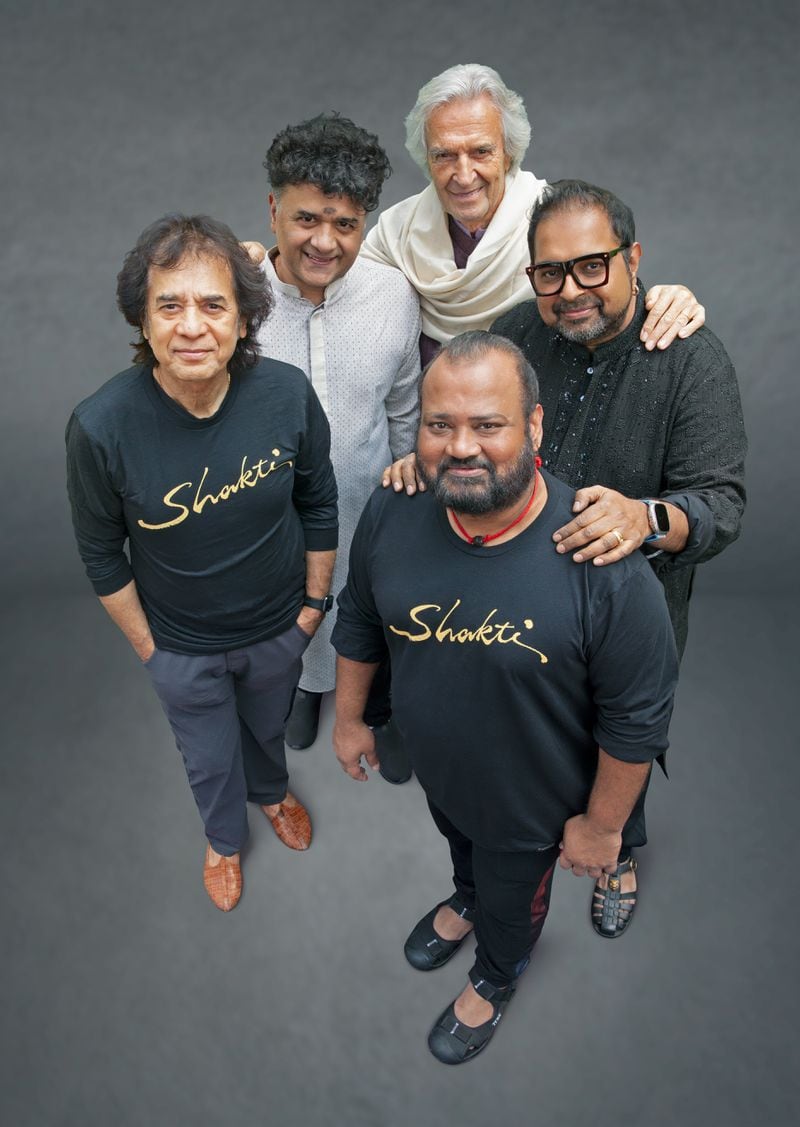 The members of Shakti, (clockwise from the left) include Zakir Hussain (tabla), Ganesh Rajagopalan (violin), John McLaughlin (guitar, guitar synthesizer), Shankar Mahadevan (vocals) and V. Selvaganesh (percussion).