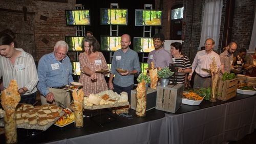A documentary played on a video board as guests enjoyed the prepared foods from local farms during the Food Well Alliance’s annual Love Local event at the King Plow Arts Center on Oct. 5. CONTRIBUTED BY PHIL SKINNER