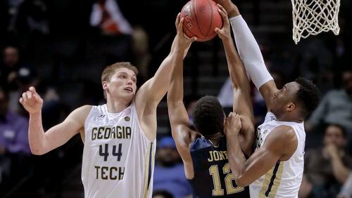 Georgia Tech center Ben Lammers (44) and guard Josh Okogie (5) block a shot attempt by Pittsburgh guard Chris Jones (12) during the second half of an NCAA college basketball game in the first round of the ACC tournament, Tuesday, March 7, 2017, in New York. Pittsburgh won 61-59. (AP Photo/Julie Jacobson)