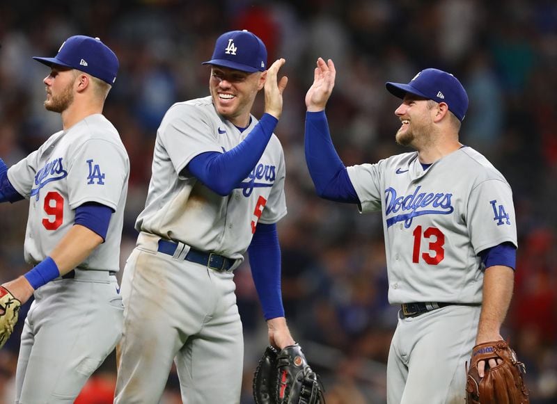 Freddie Freeman (center) and Max Muncy celebrate a 4-1 victory over the Atlanta Braves in a MLB baseball game on Friday, June 24, 2022, in Atlanta.   “Curtis Compton / Curtis.Compton@ajc.com”