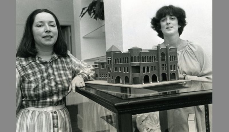 Paula Wallace, at left, and an instructor pose in 1979 with a model of the first building opened by the Savannah College of Art and Design in 1979. HERB PILCHER/Savannah Morning News