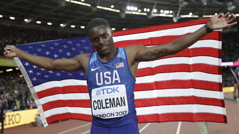United States' silver medal winner Christian Coleman, of Atlanta,  poses with his national flag after the men's 100m final during the World Athletics Championships in London Saturday, Aug. 5, 2017.