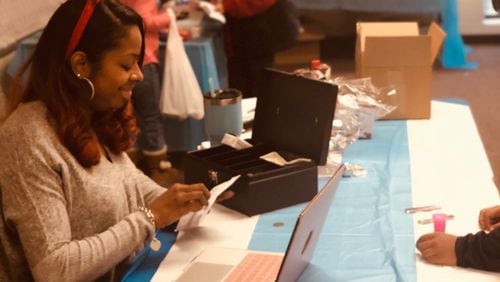 Meshana Spivey, president of the Magill Elementary PTA helps out during a winter fundraiser holiday store called the Peguin Patch. Spivey was named by the Georgia Department of Education and the Georgia PTA as an outstanding parent volunteer. CONTRIBUTED
