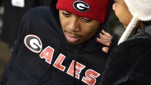 Devon Gales, the Southern University player paralyzed in a early season game against Georgia, chats with his sister Teah Gales ,7, before the start  of the game Saturday.  Gales  was greeted by players as they entered the stadium  in Athens Saturday November 21, 2015.  Gales has received an out pouring of support from the University of Georgia. BRANT SANDERLIN/BSANDERLIN@AJC.COM
