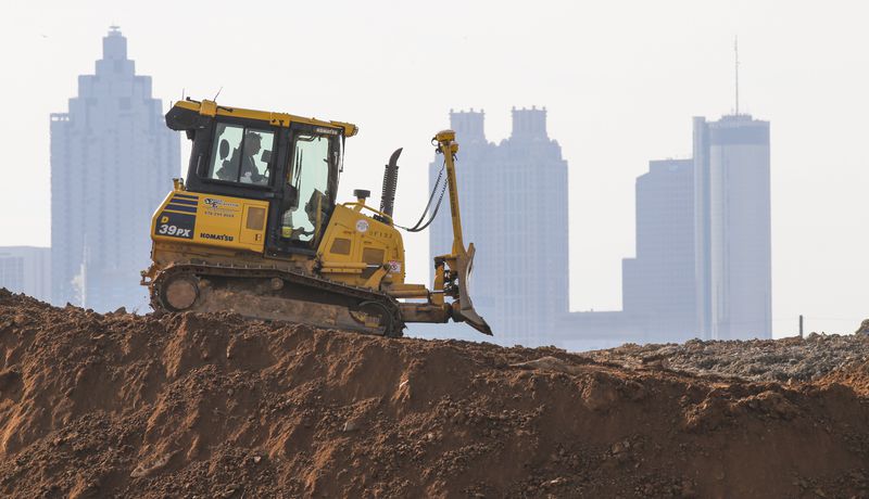 A lone bulldozer with Eagle Excavation merged with the Atlanta skyline as the operator worked at the site of a new Kroger at 17th and Northside Drive. 