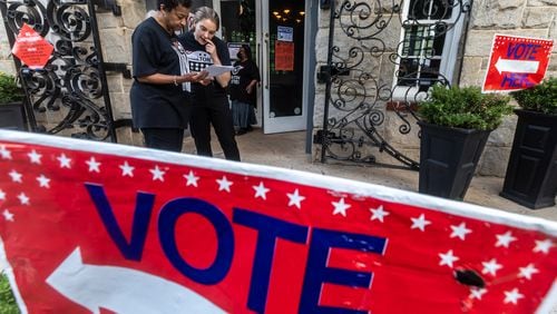 Cathy Anderson (left) goes over some last minute preparation with poll manager, Alex (right) at the polling place at the Park Tavern located at 500 10th Street NE in Atlanta on Tuesday, May 21, 2024. Some races will be settled by runoff elections on Tuesday, June 18. (John Spink/AJC)