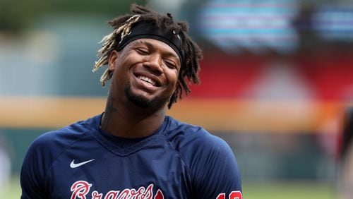 Braves right fielder Ronald Acuna Jr. talks with teammates before their game against the Los Angeles Dodgers at Truist Park, Tuesday, May 23, 2023, in Atlanta.  (Jason Getz / Jason.Getz@ajc.com)
