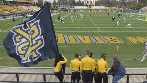 A Kennesaw State University flag flies in the south end zone prior to the start of an Owls’ football game last year. Kennesaw is the site of renewed debate about language and gender. File photo